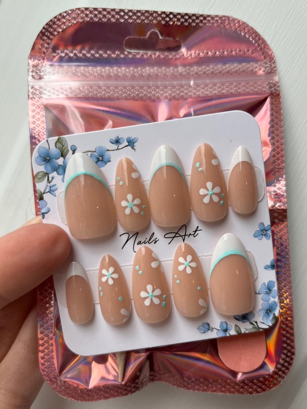Handmade Almond Press on Nails featuring French tip, flowers, white and blue